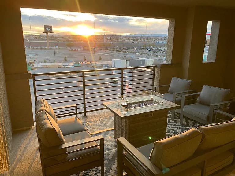 Same balcony at golden hour with sunset over the valley and mountains